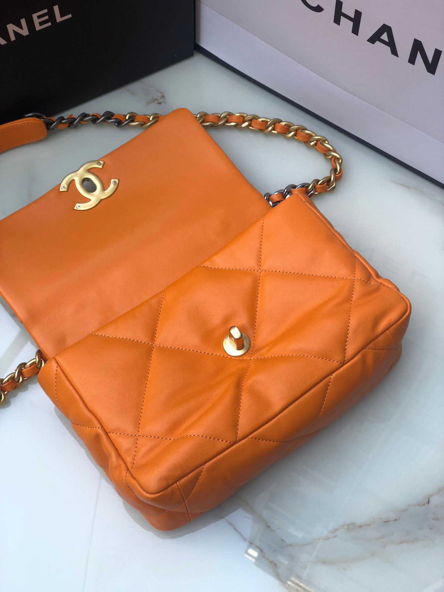 Ch*el 19 handbag shiny leather, gold-tone, silver-tone & ruthenium-finish metal orange 6.2 × 10.1 × 3.5 in