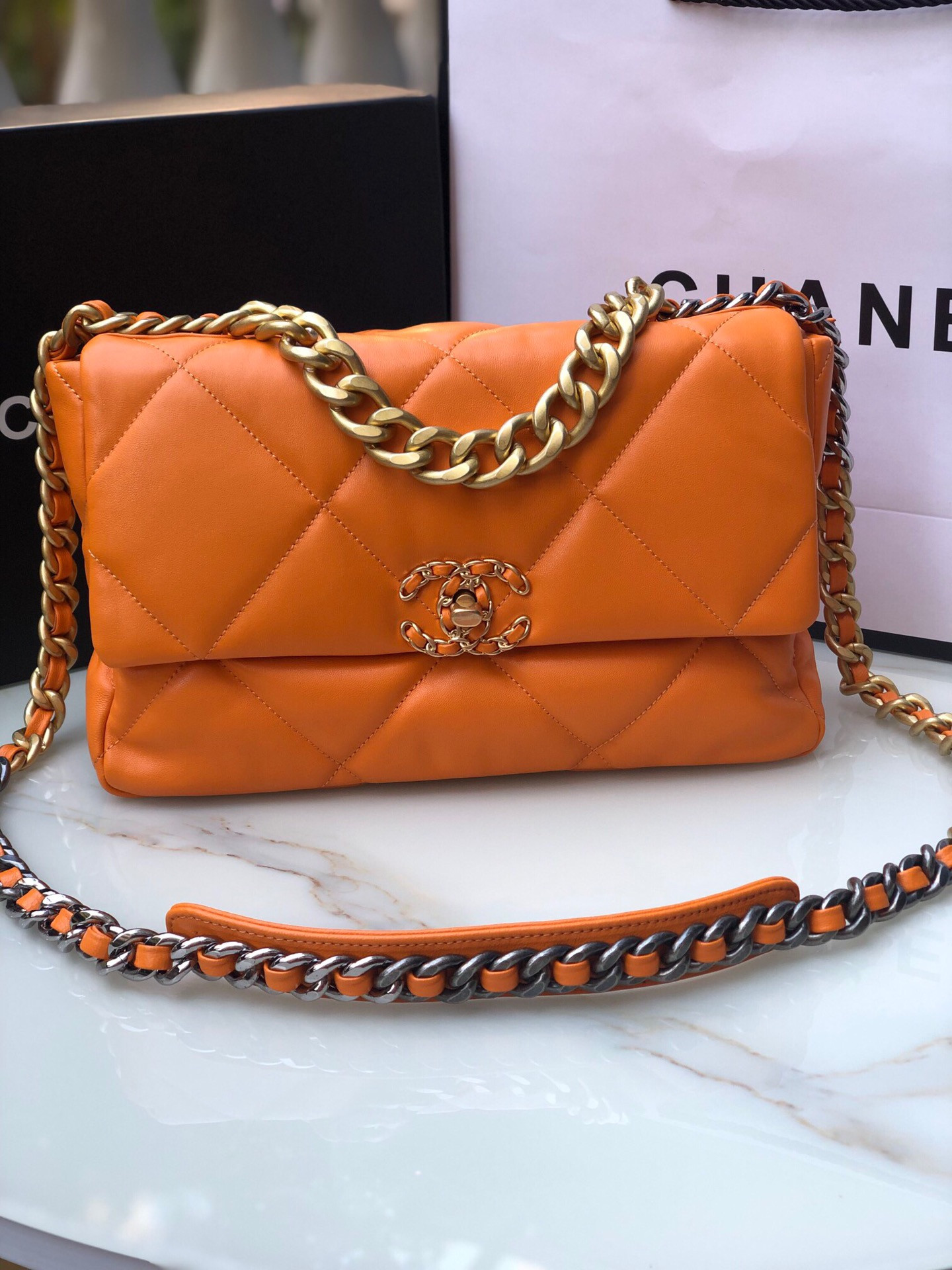 Ch*el 19 large handbag shiny leather, gold-tone, silver-tone & ruthenium-finish metal orange 7.8 × 11.7 × 3.9 in